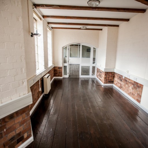Exposed brick and natural wooden floors.